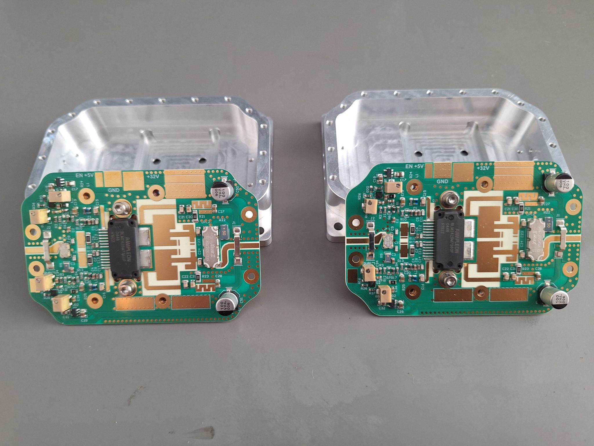 Two open E-REON 60 W RF amplifier modules showing their internal circuit assemblies