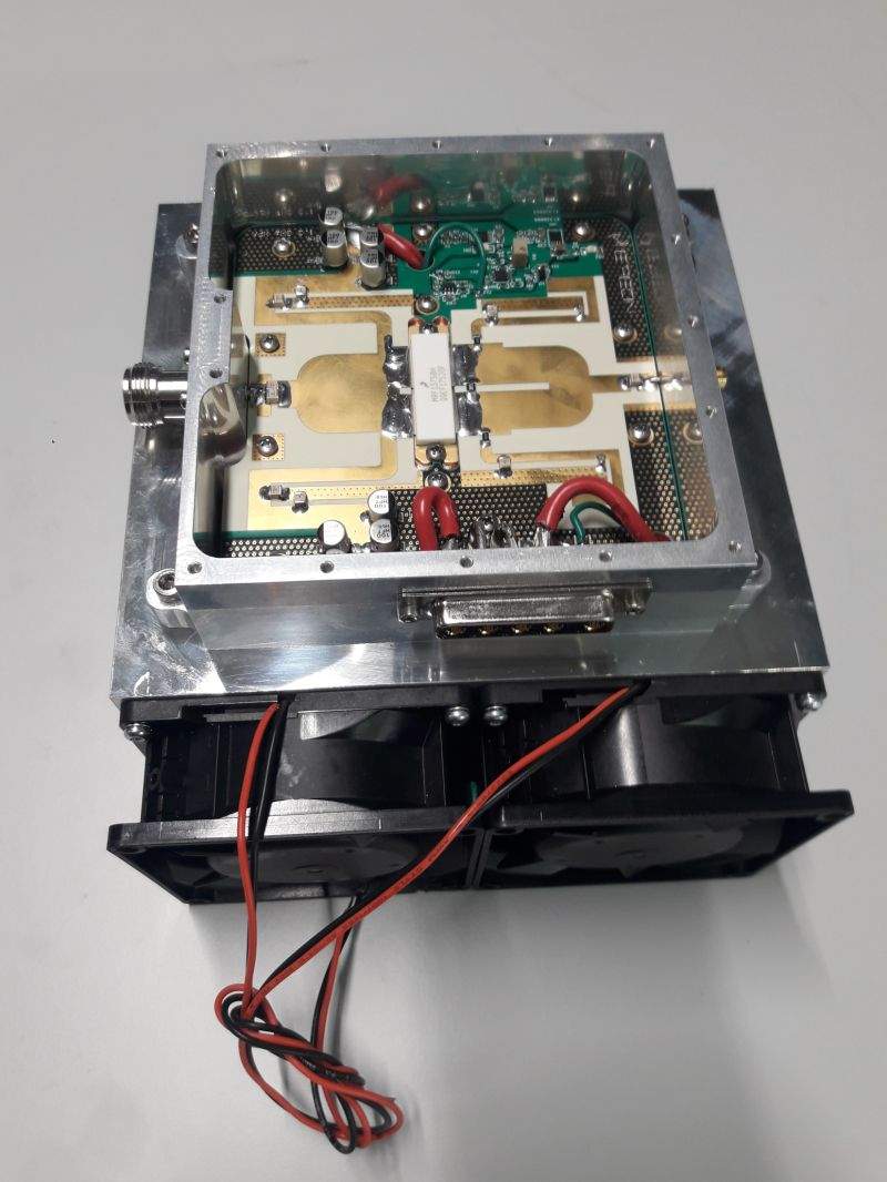 Open 750 W L-band high-power amplifier assembly with its RF board and cooling fans visible
